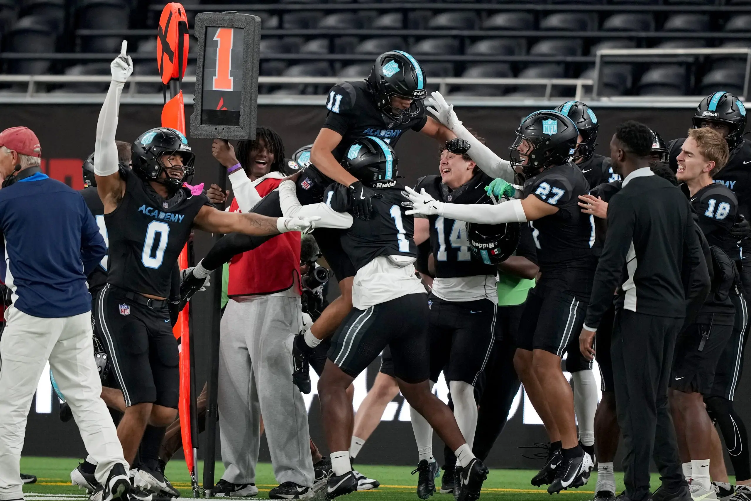 NFL Academy’s Jayden Smith (11) celebrates with teammates after scoring a touchdown against St. Thomas Aquinas on Wednesday, Oct. 8, 2025 at Tottenham Stadium in London. (Sean Ryan/AP Content Services for the NFL)